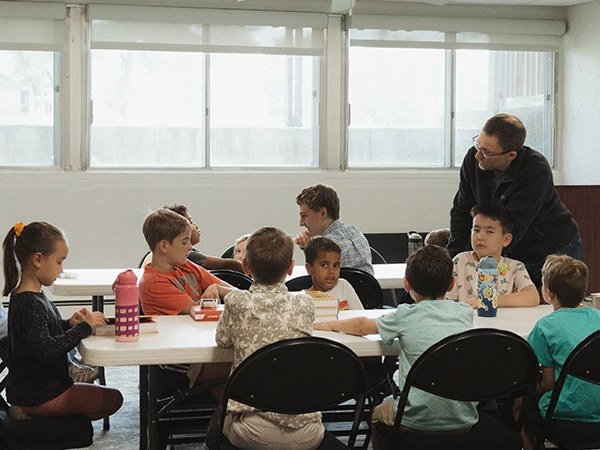A group of kids hanging out on the sidewalk