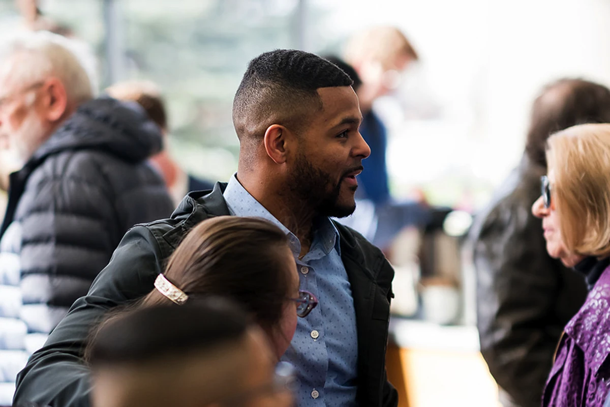 Women helping children at a registration table.