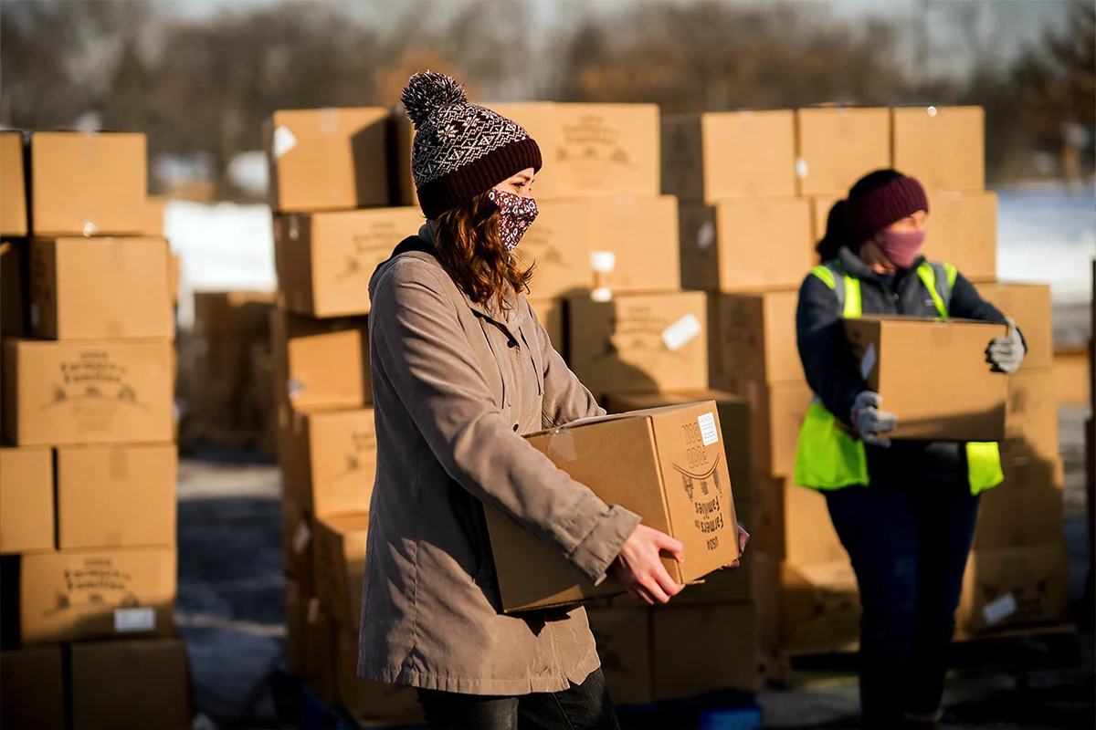 Women helping children at a registration table. Women helping children at a registration table.