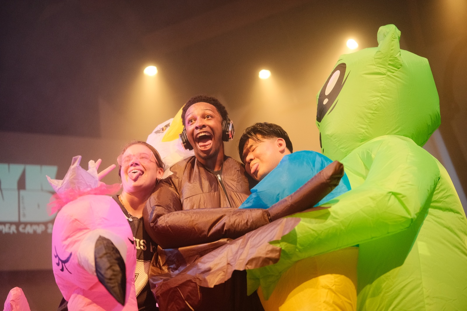 Friends laughing together in colorful inflatable costumes