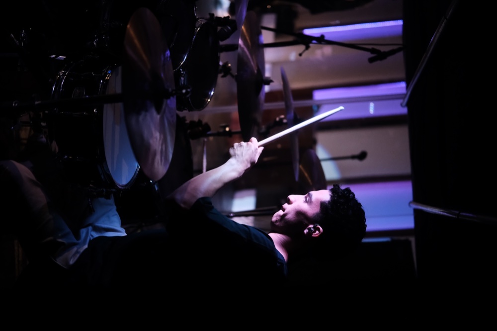A drummer playing during worship
