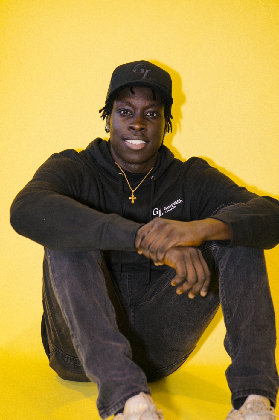 A man wearing a black Gospelife hoodie and cap