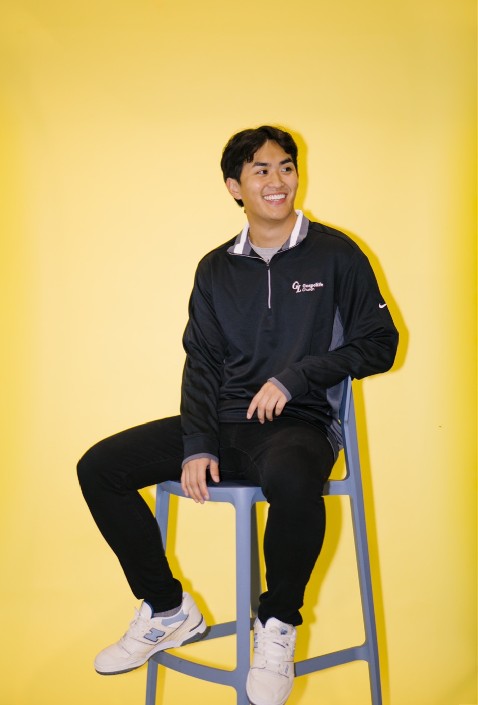 A man wearing a black Gospelife quarter-zip pullover